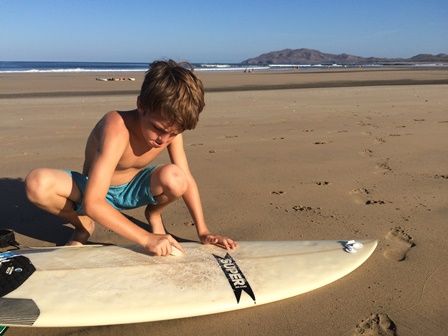 Charlie getting ready to surf at Playa Tamarindo